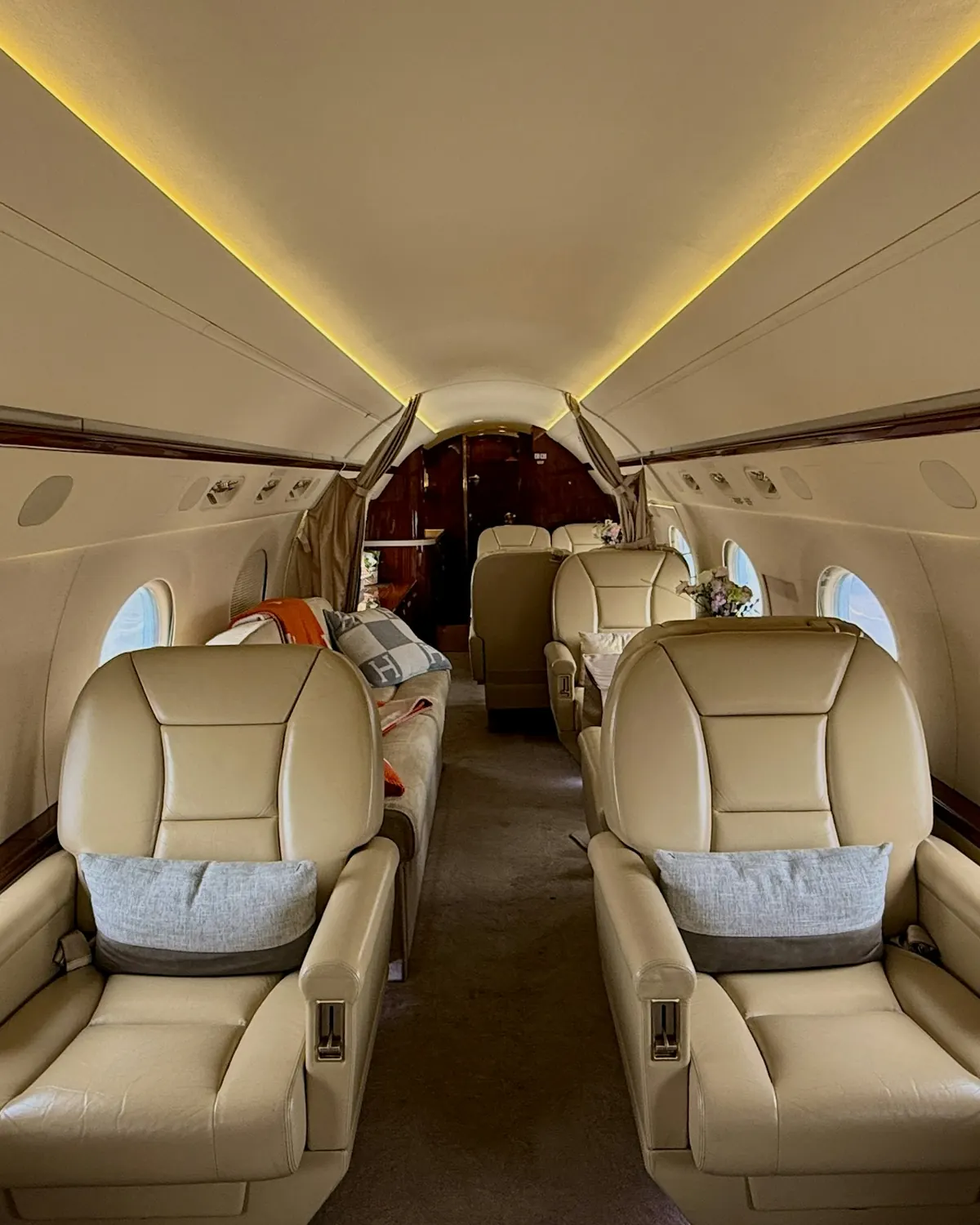 Leather seats in a warmly lit private jet cabin