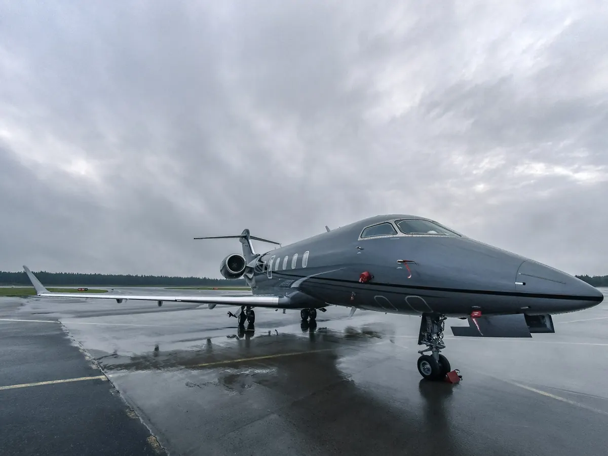 Gulfstream business jet on a wet ramp at dusk