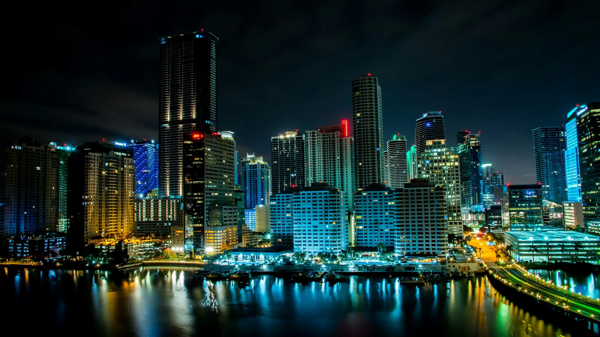 Miami skyline lit up at night across the water